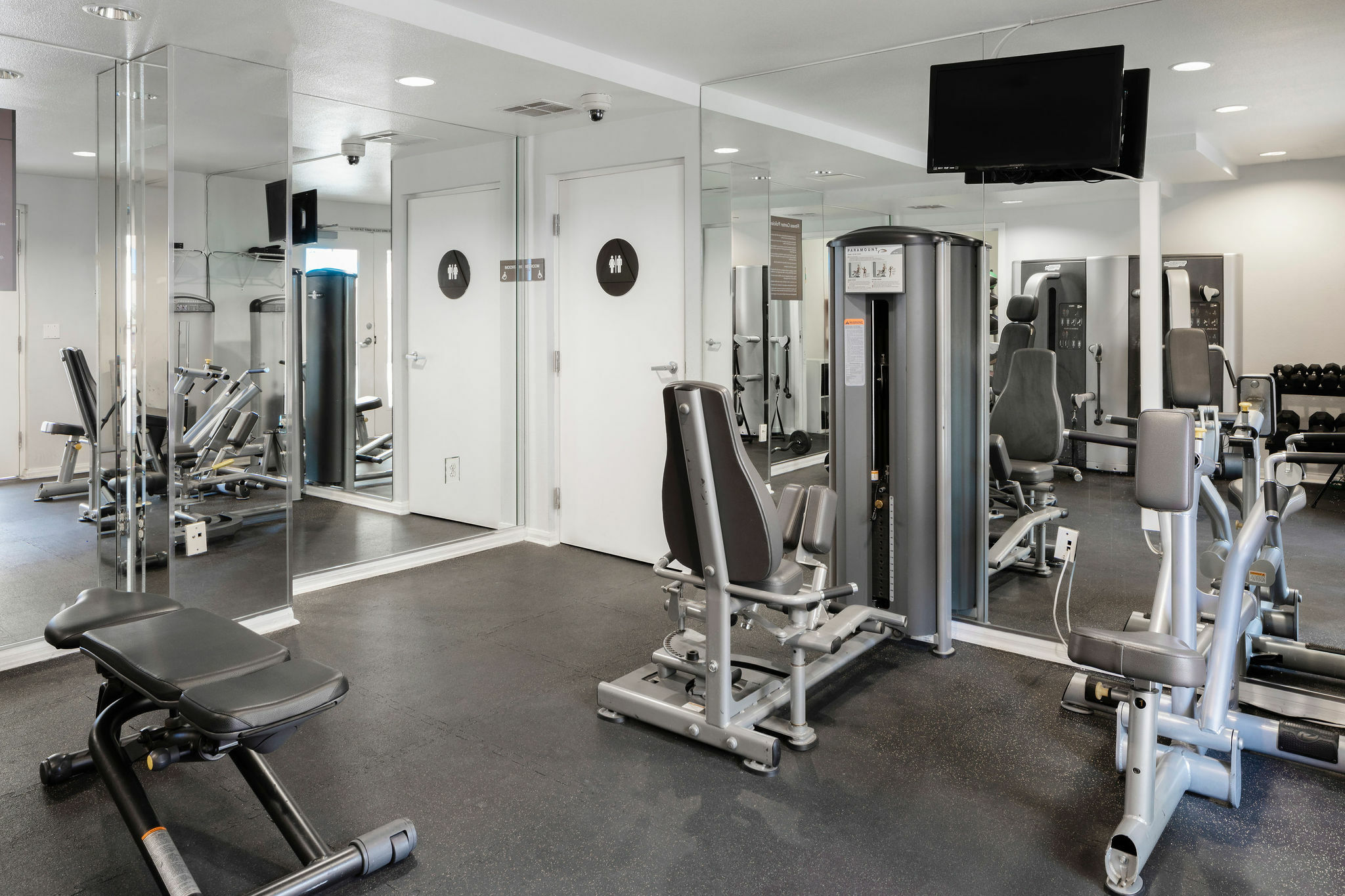 interior of gym with fitness equipment and mirrors