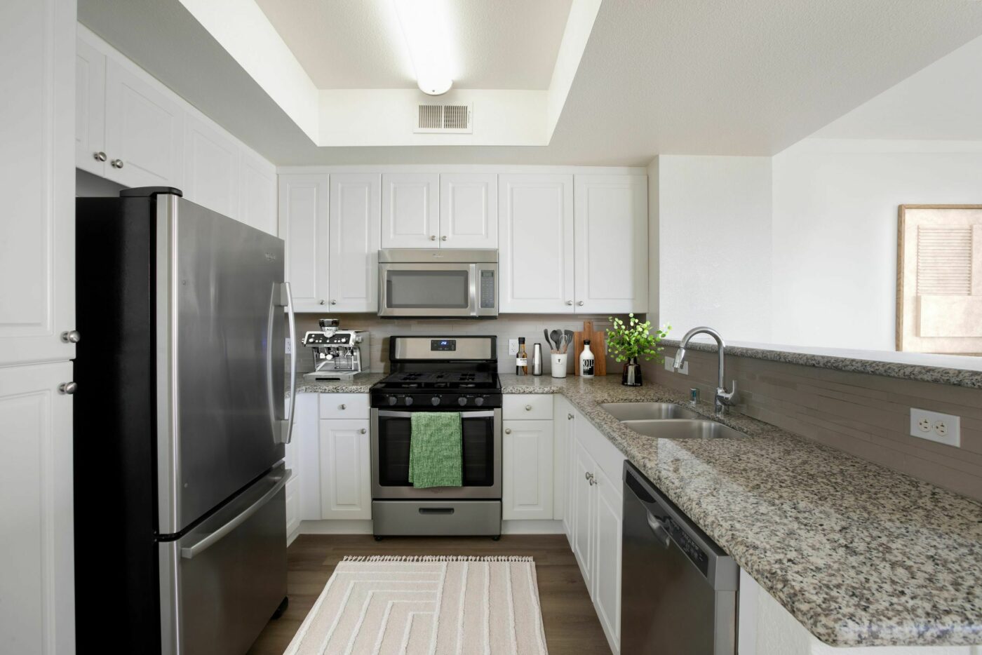 kitchen with speckled countertops and stainless steel appliances